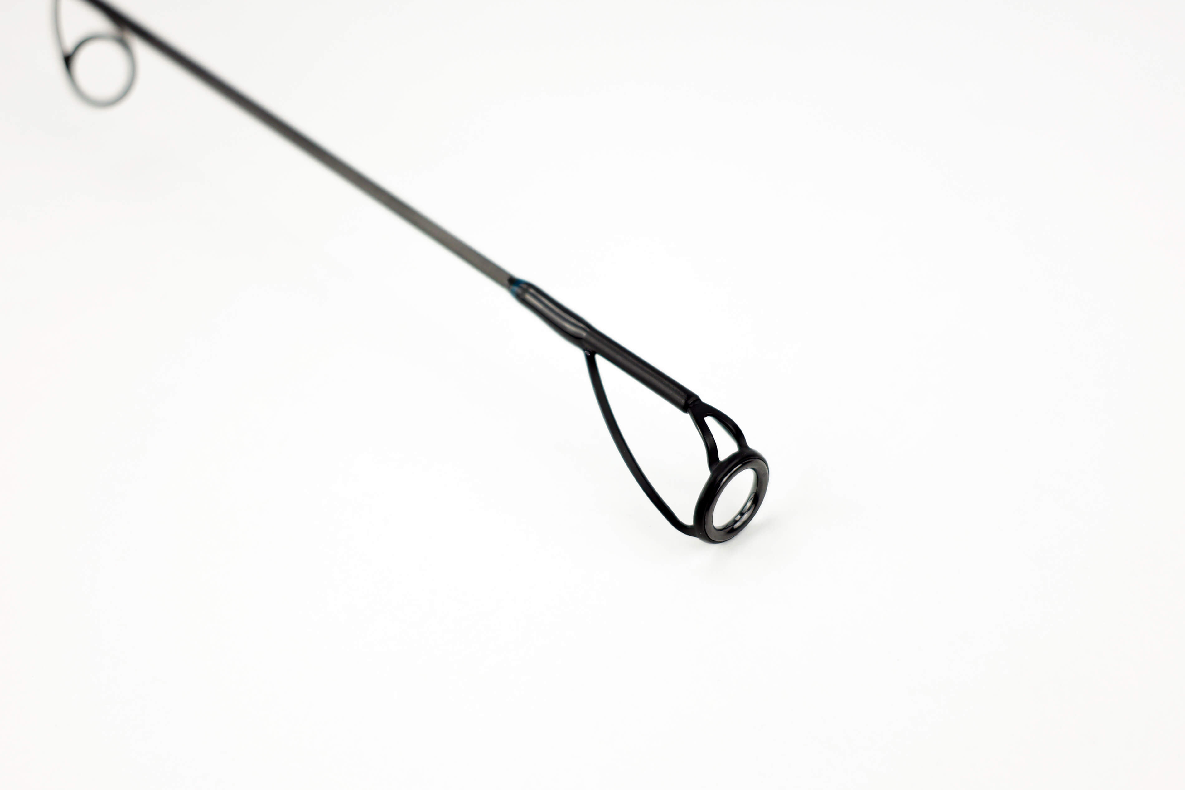Primer plano de la punta de una caña de pescar, imprescindible para las aventuras de pesca de carpas.